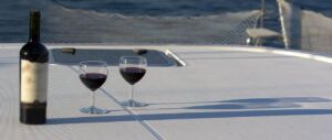 Butelka czerwonego wina i dwa kieliszki na pokładzie katamaranu Nautitech 40 open. Wyspa Vis, rejs rodzinny po wodach Chorwacji